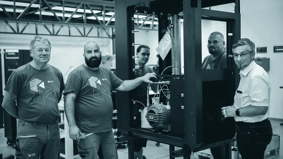 AMT engineers with a machine frame during assembly