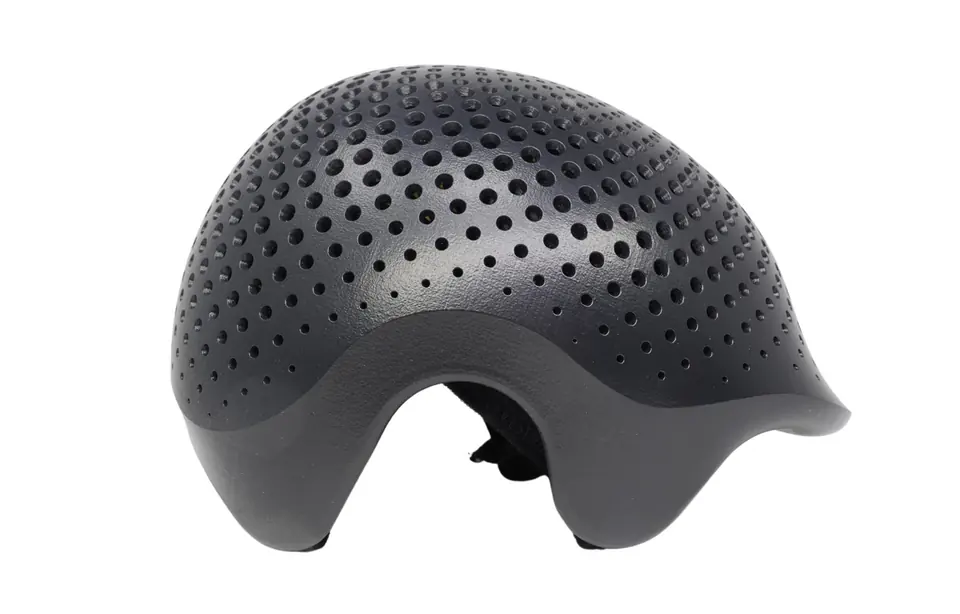 The same helmet shell after PostPro vapor smoothing, with a smooth, sealed dark surface