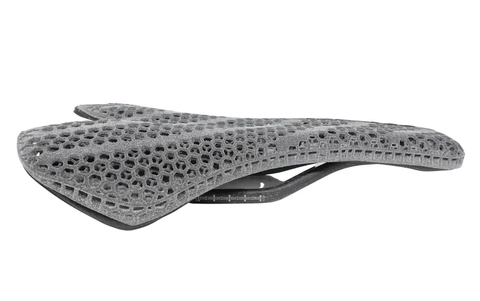 3D-printed lattice bicycle saddle as printed, with a rough gray surface