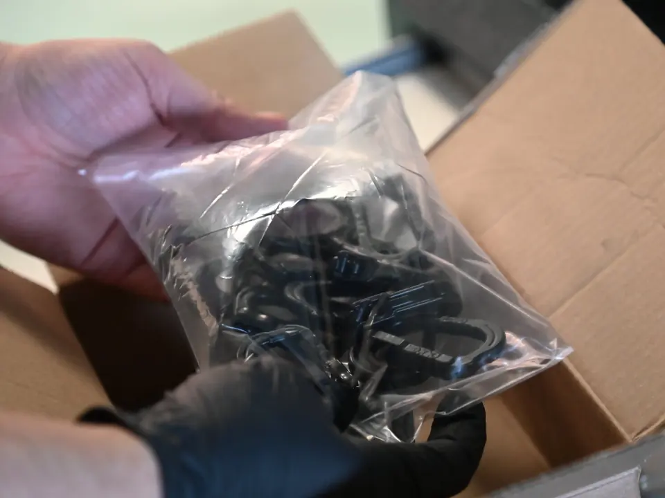 The same parts after vapor smoothing, now black and glossy, bagged to ship back